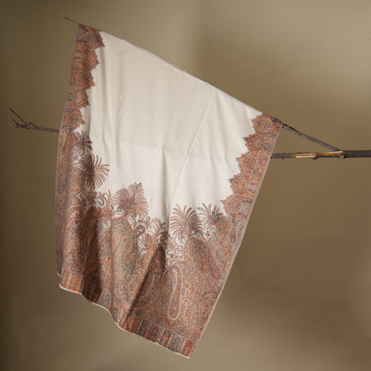 Decorative blanket with intricate patterns hanging on a stick against a beige background shop at earthandoak